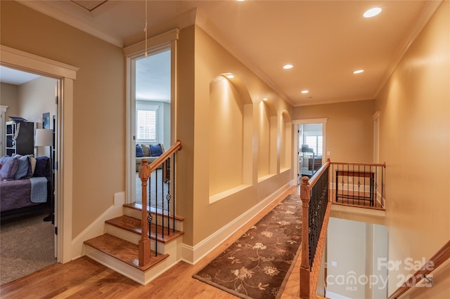 hall featuring ornamental molding, recessed lighting, baseboards, and wood finished floors