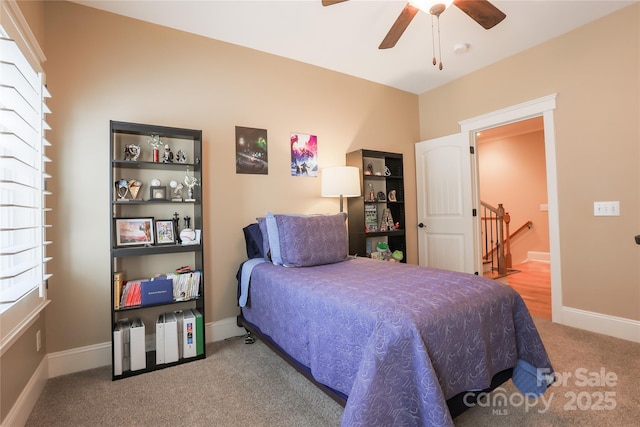 carpeted bedroom featuring ceiling fan and baseboards