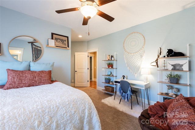 bedroom with a ceiling fan, carpet flooring, and baseboards