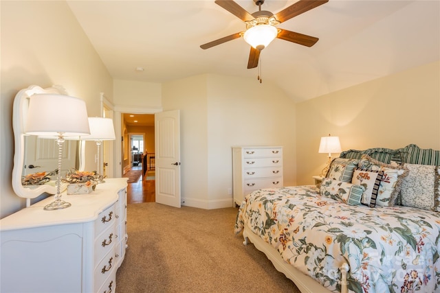 bedroom with lofted ceiling, light colored carpet, ceiling fan, and baseboards