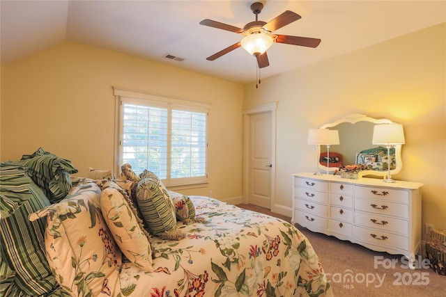 carpeted bedroom with lofted ceiling, ceiling fan, and visible vents