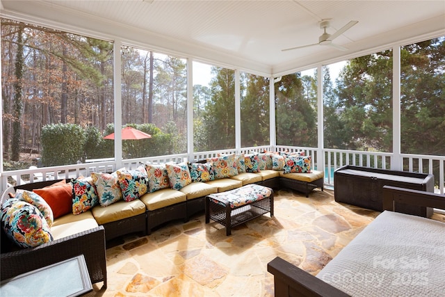 sunroom / solarium with a ceiling fan