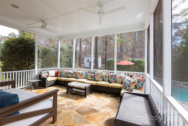 sunroom / solarium featuring ceiling fan