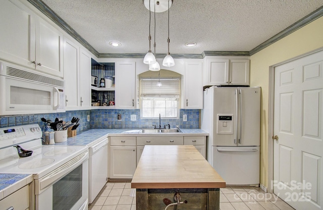 kitchen with white appliances, hanging light fixtures, white cabinetry, open shelves, and a sink