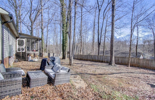 view of yard featuring a sunroom and a fenced backyard