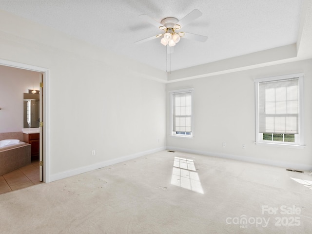 unfurnished bedroom with carpet, a textured ceiling, and baseboards