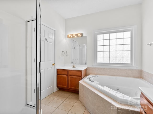 full bath featuring tile patterned floors, a shower stall, a tub with jets, and vanity