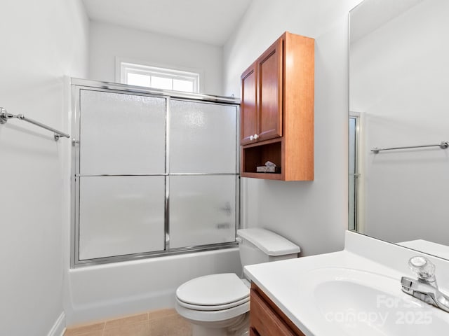 full bath with toilet, tile patterned flooring, combined bath / shower with glass door, and vanity