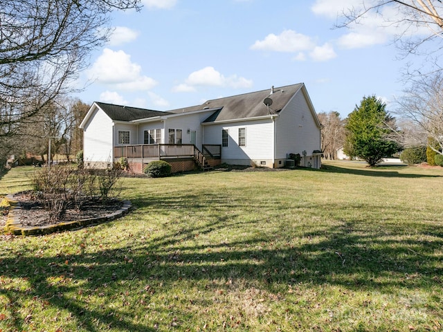 rear view of house featuring a deck, cooling unit, and a yard