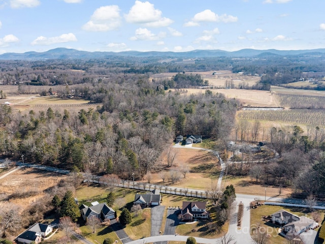 drone / aerial view featuring a forest view and a mountain view