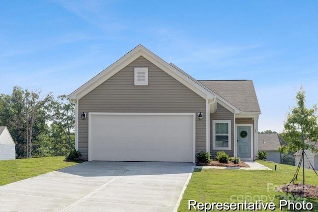 view of front of property featuring a garage, driveway, and a front yard