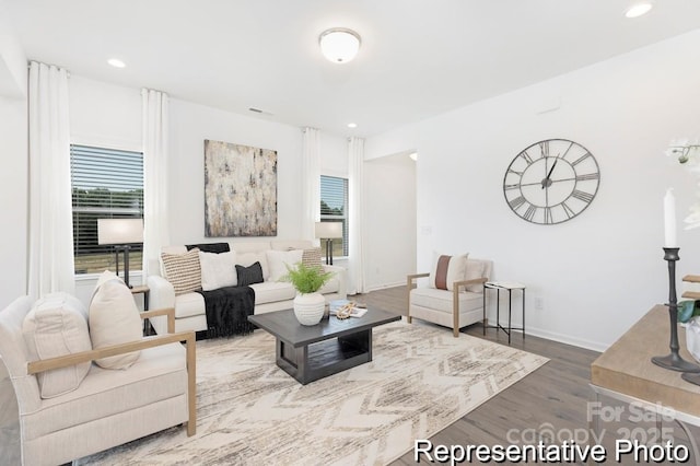 living room with recessed lighting, baseboards, and wood finished floors