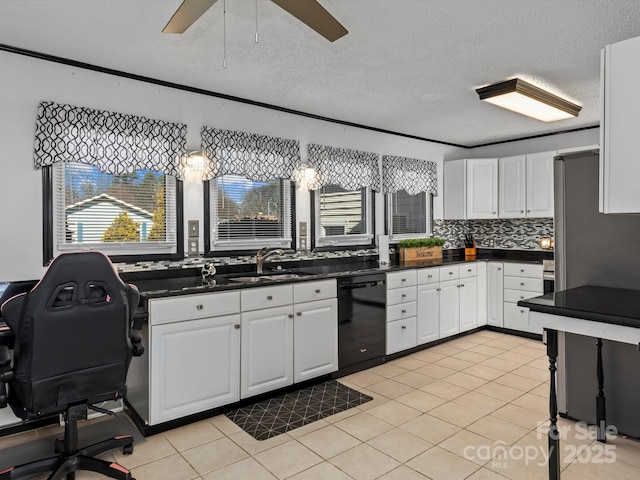 kitchen featuring dark countertops, black dishwasher, white cabinetry, and a sink