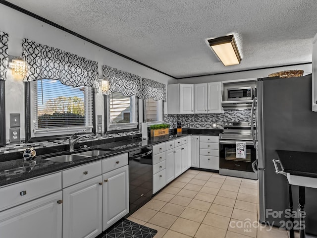 kitchen with stainless steel appliances, white cabinets, and a sink