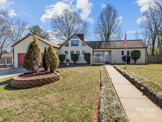 view of front of home with an attached garage, fence, concrete driveway, roof with shingles, and a front lawn