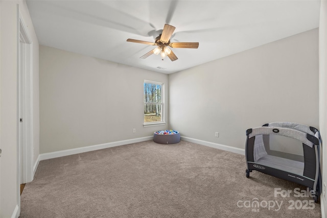 interior space with carpet, visible vents, ceiling fan, and baseboards