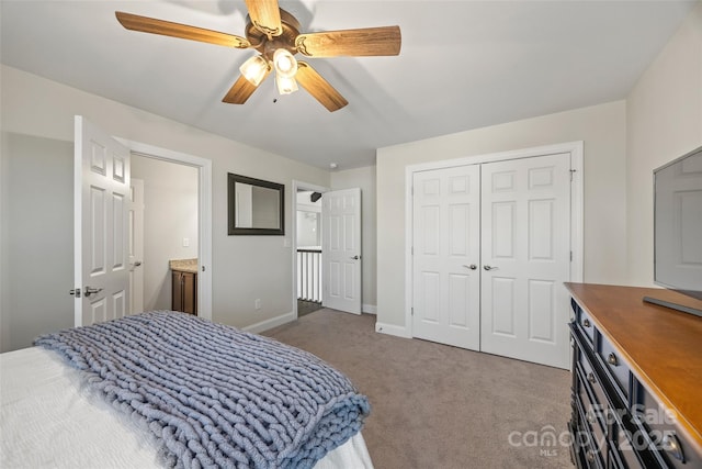 carpeted bedroom featuring a ceiling fan, a closet, and baseboards