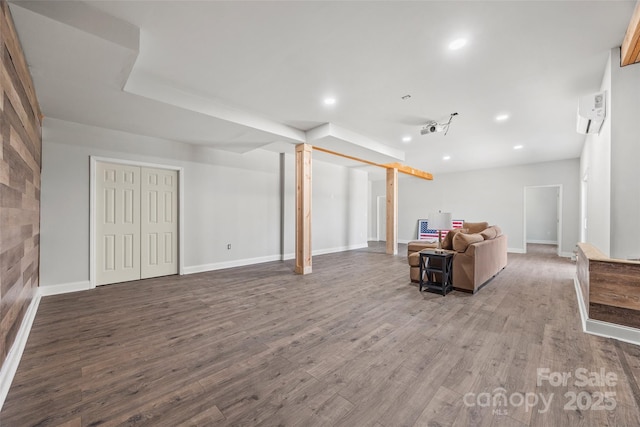 unfurnished living room featuring recessed lighting, a wall mounted air conditioner, baseboards, and wood finished floors