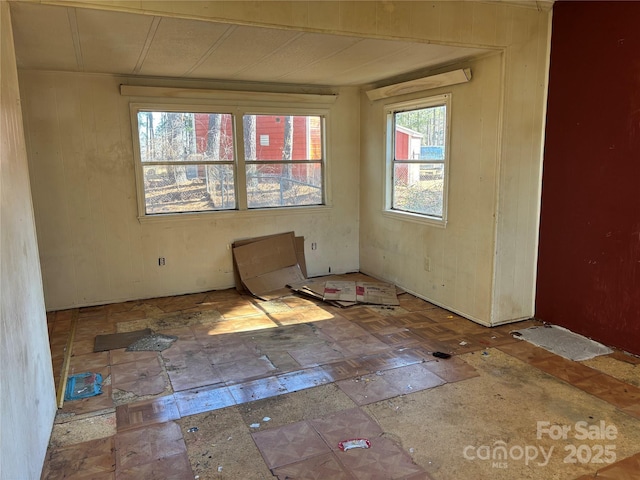 unfurnished room featuring stone tile flooring