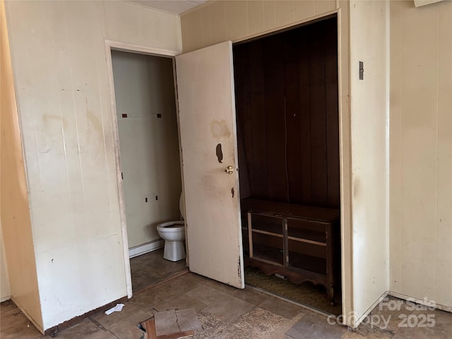 bathroom featuring toilet and a baseboard heating unit