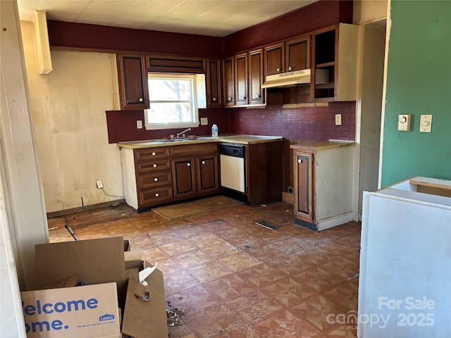 kitchen with tasteful backsplash, dishwasher, light countertops, under cabinet range hood, and a sink