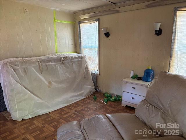 bedroom featuring wooden walls