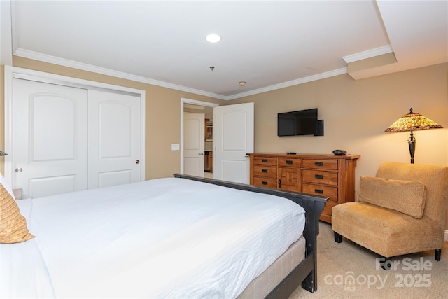 bedroom featuring light carpet, a closet, and crown molding