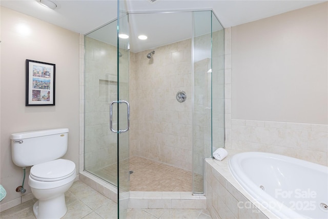 bathroom featuring a garden tub, a shower stall, toilet, and tile patterned floors