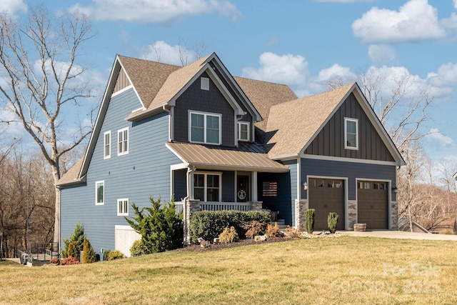 craftsman-style house with a shingled roof, concrete driveway, covered porch, a front lawn, and board and batten siding