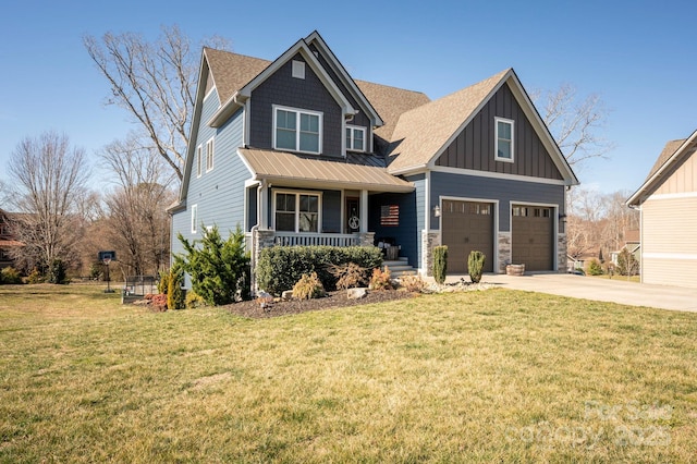 craftsman-style home with driveway, a garage, a porch, board and batten siding, and a front yard