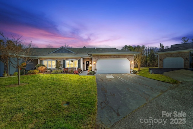 ranch-style house featuring concrete driveway, an attached garage, a lawn, and brick siding