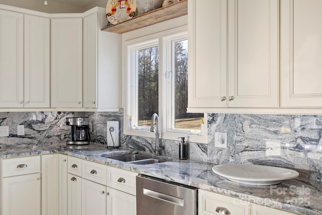 kitchen with tasteful backsplash, dishwasher, light stone countertops, and a sink