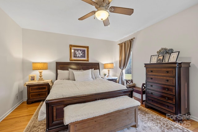 bedroom featuring baseboards, ceiling fan, and light wood finished floors