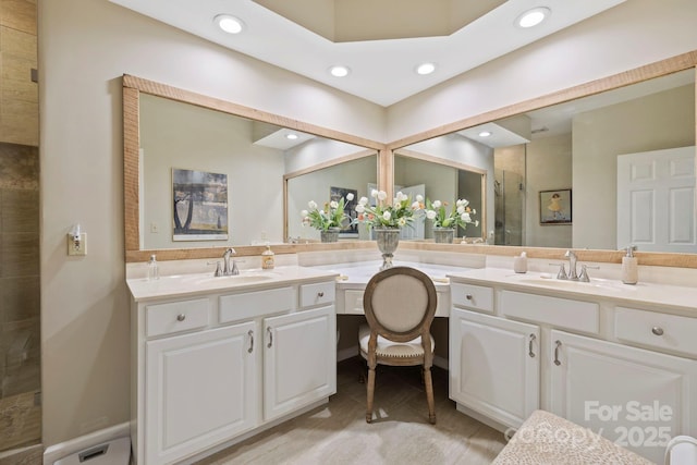 bathroom with recessed lighting, vanity, and a shower stall