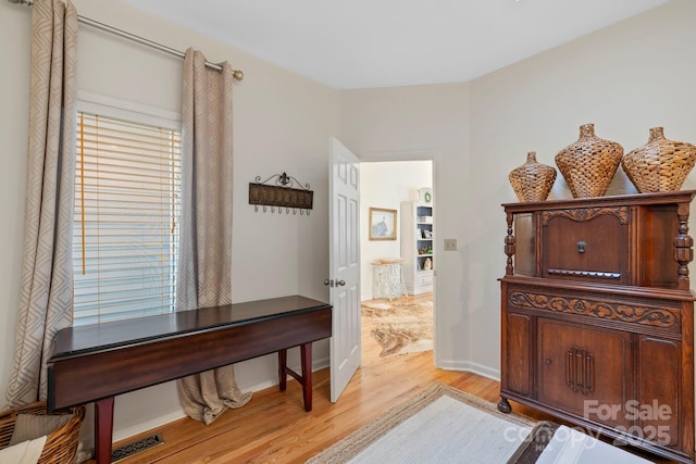 interior space featuring light wood finished floors, visible vents, and baseboards