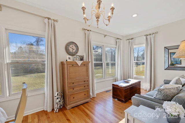 sitting room with visible vents, recessed lighting, light wood finished floors, baseboards, and a chandelier