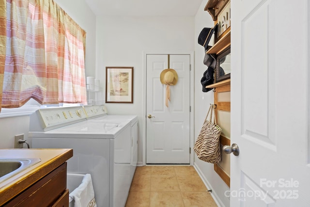 laundry area with light tile patterned floors, laundry area, baseboards, and separate washer and dryer