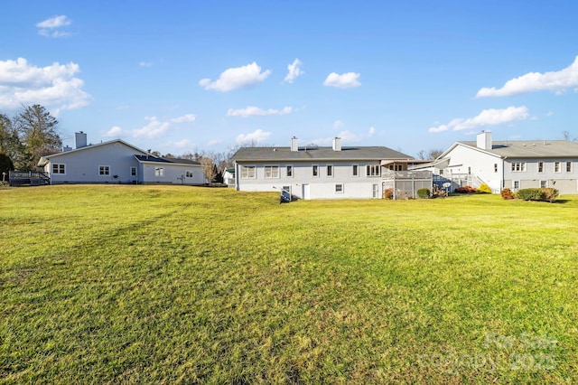 back of house with a lawn