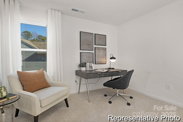 home office featuring baseboards, visible vents, and light colored carpet