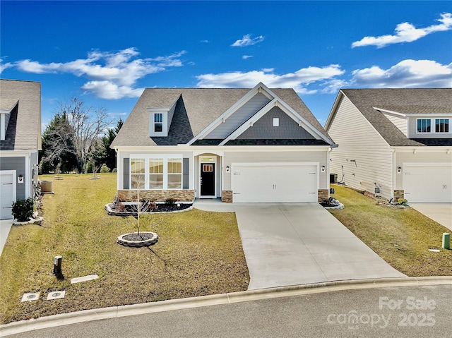 view of front of home featuring a garage, roof with shingles, driveway, and a front lawn