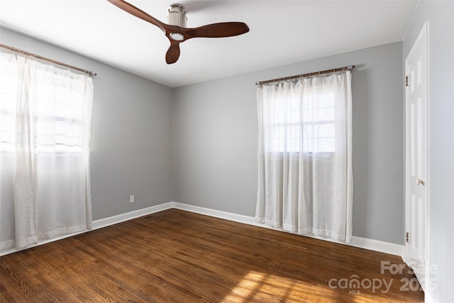 unfurnished room featuring wood finished floors, a ceiling fan, and baseboards