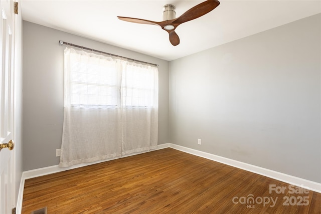 unfurnished room with visible vents, ceiling fan, baseboards, and wood finished floors