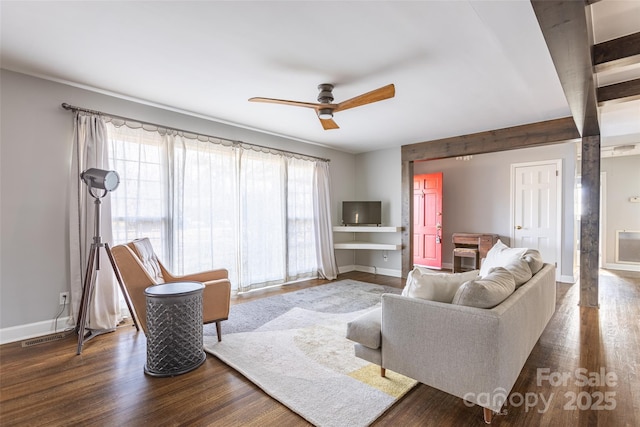 living area featuring dark wood-style flooring, ceiling fan, and baseboards