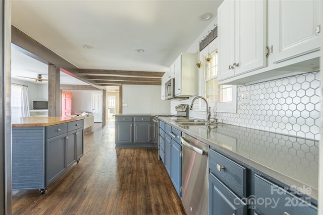 kitchen featuring a sink, appliances with stainless steel finishes, white cabinets, and wooden counters