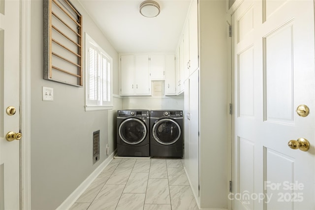 washroom with cabinet space, baseboards, visible vents, marble finish floor, and separate washer and dryer