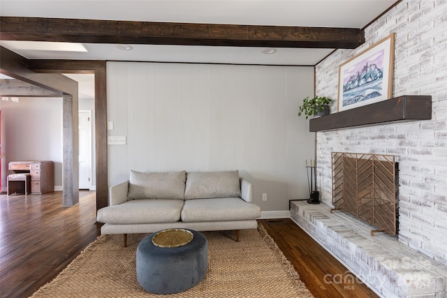 living room featuring a fireplace, baseboards, dark wood-type flooring, and beam ceiling