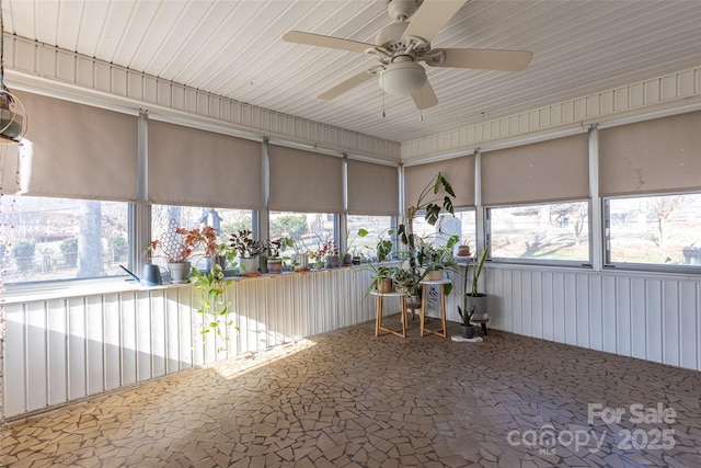 unfurnished sunroom featuring ceiling fan