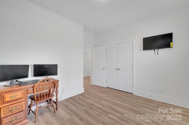 home office with light wood finished floors and baseboards