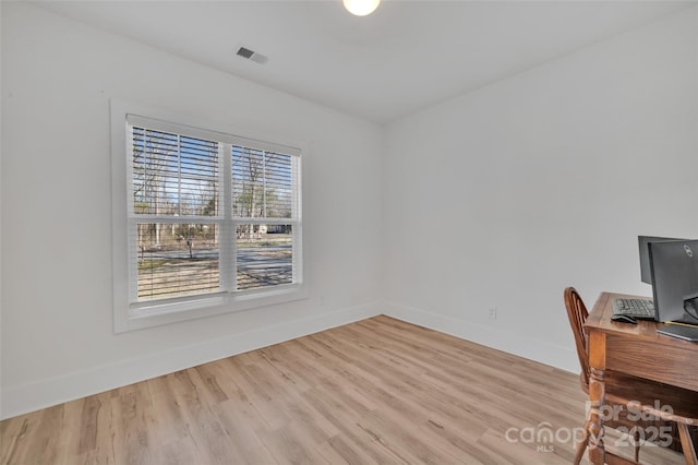 office area featuring light wood-style flooring, visible vents, and baseboards