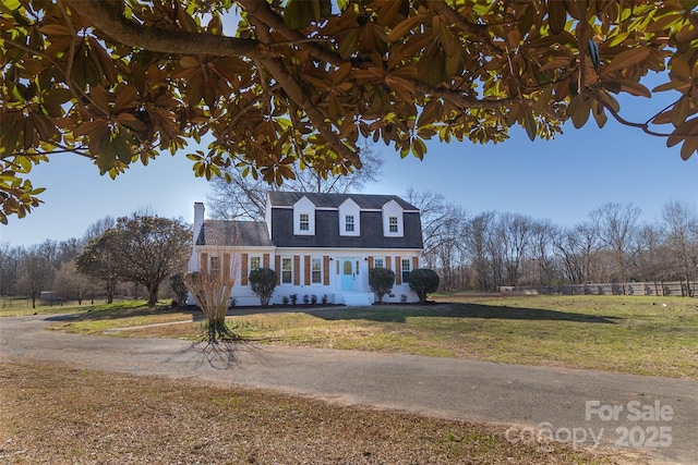 dutch colonial featuring a front lawn and fence